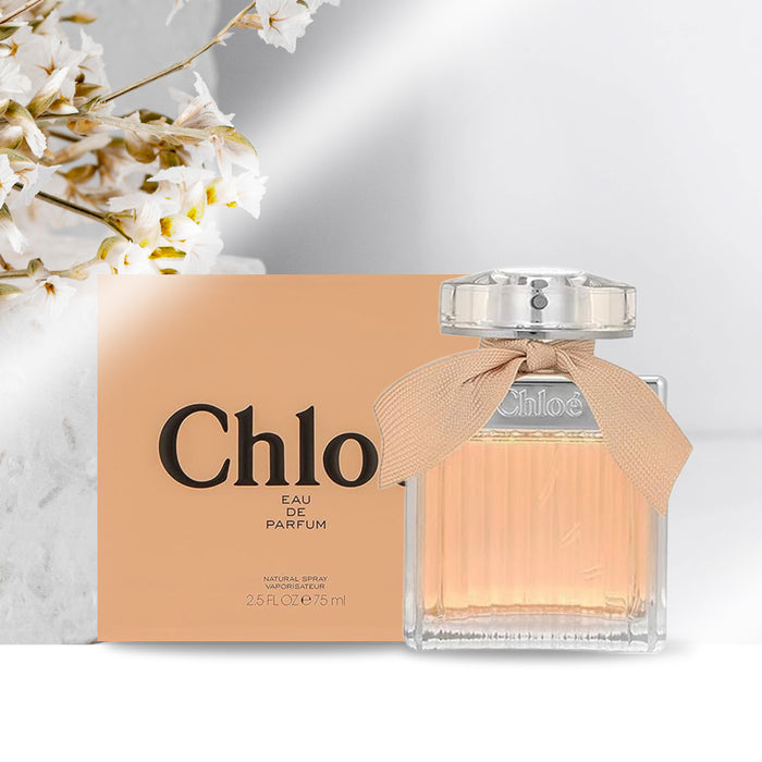 Chloe Eau de Parfum in clear square glass bottle with ridged texture, round flat chrome cover and pastle ribbon